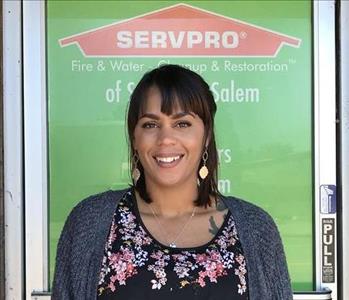 Female employee smiling with green background 